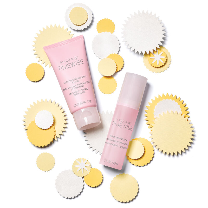 Mary Kay Microdermabrasian Refine and Pore Minimizer products are shot from above atop and alongside white and yellow paper cutouts.