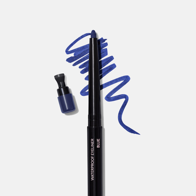 Uncapped Mary Kay Waterproof Eyeliner in Blue against product rub next to sharpener cap