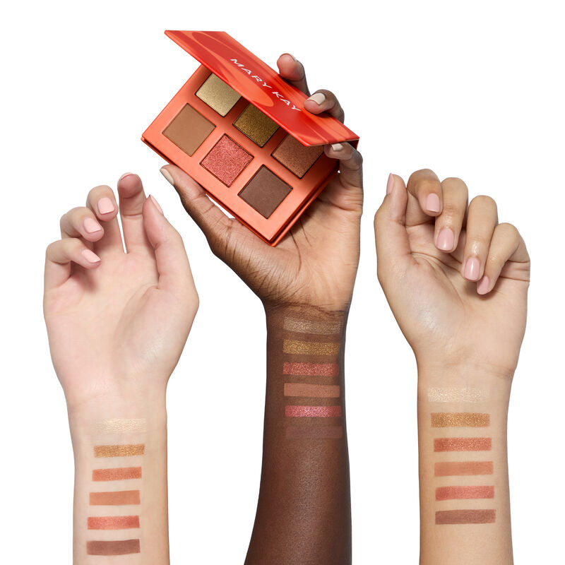 Swatches of all six colors from the limited-edition Mary Kay Eye Shadow Palette in Outer Glow on light, deep and medium skin-toned arms against white 